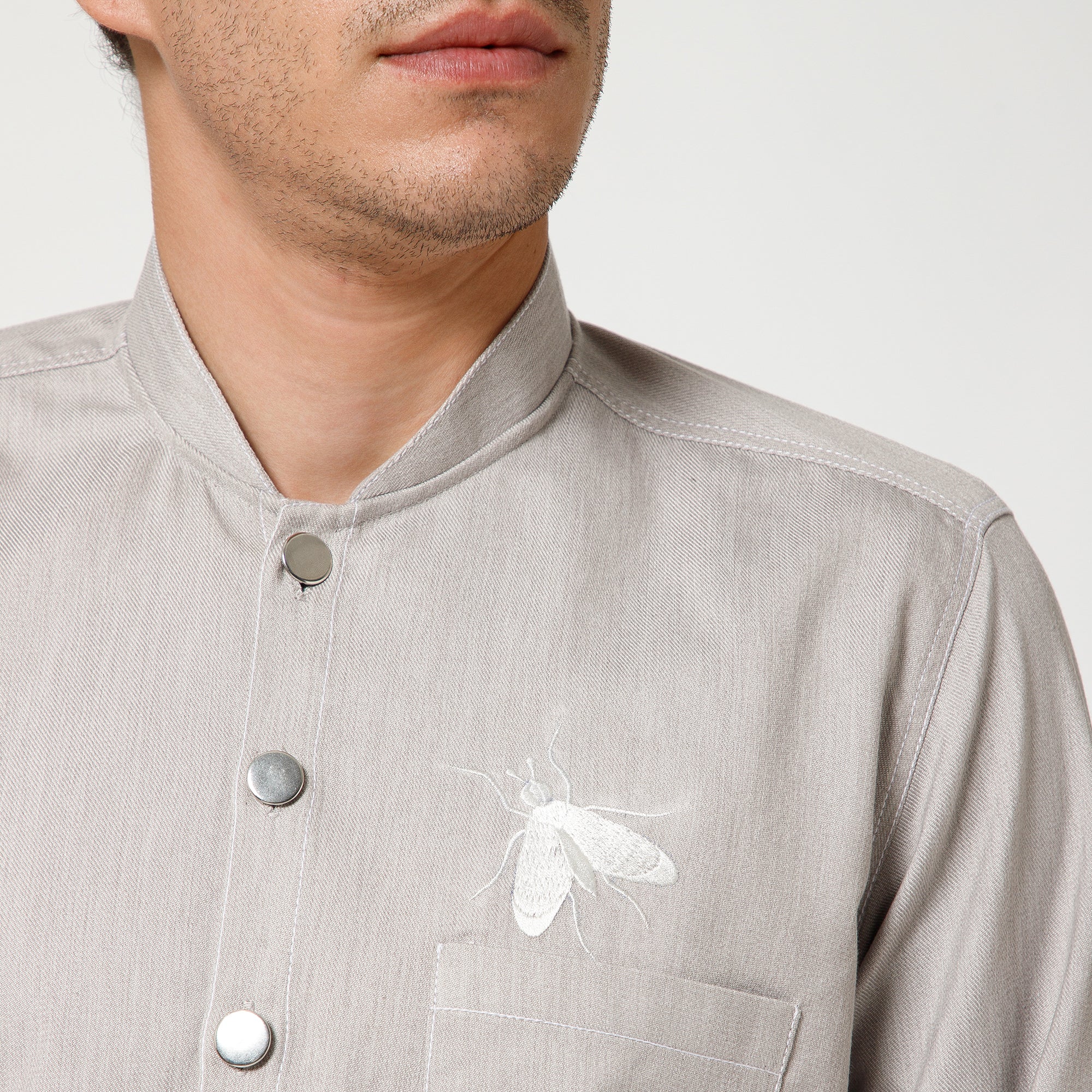 Grey Denim Jacket With White Top Stitch And White Fly